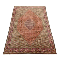  Persian Bijar rug carpet, central lozenge within larger lozenge, all over Heratti motif decoration, five band border with stylised flower heads and scrolls, 350cm x 250cm  