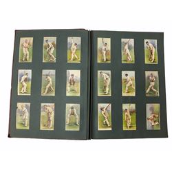 Two albums of cricketing cigarette cards by Players and Wills; three unopened early packets of cigarettes; quantity of empty cigarette packets; coal carving; and other collector's items