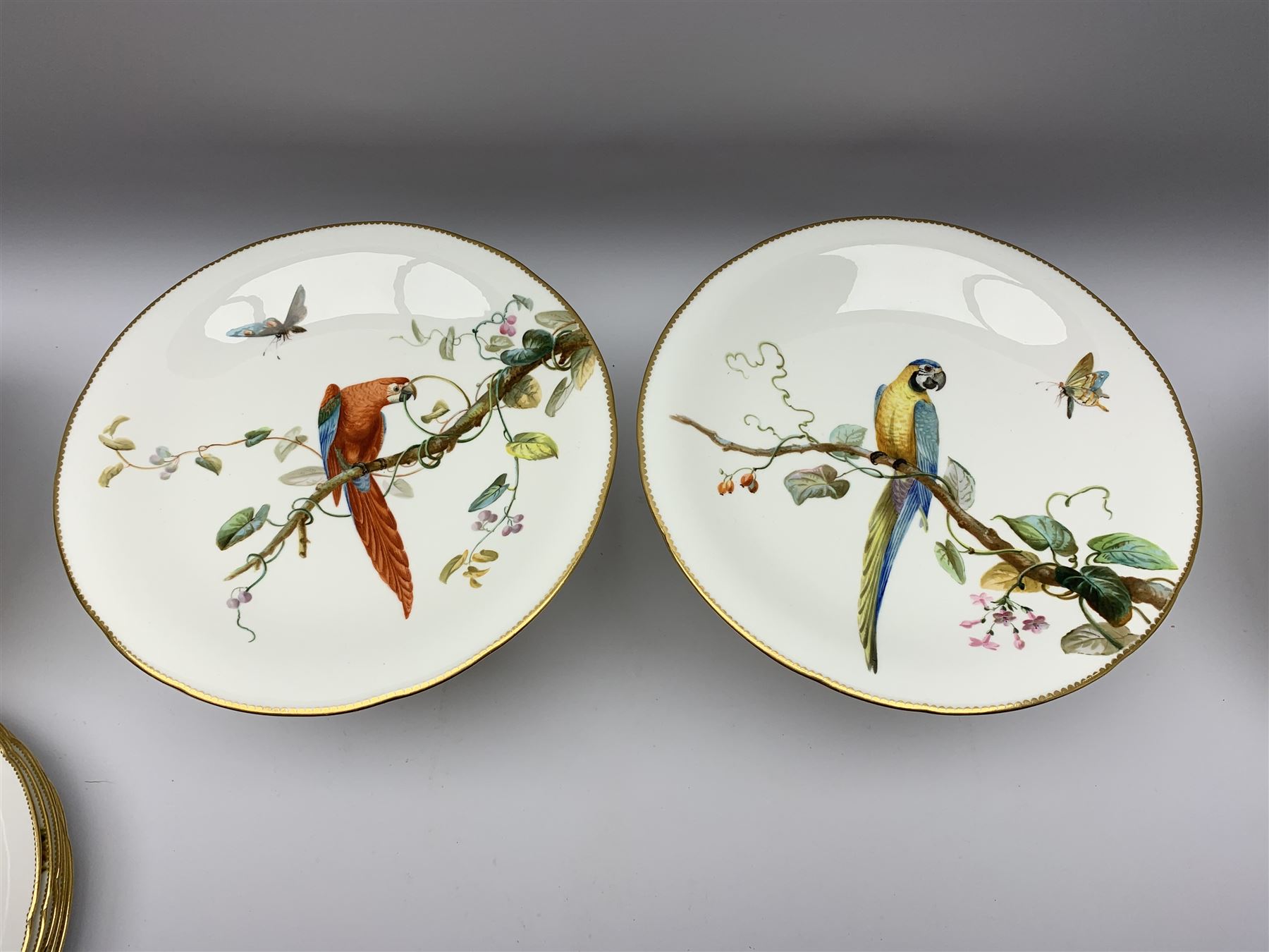 19th century Minton dessert service, comprising four comports, one tazza, and twelve plates, each hand painted with birds perched upon branches, and further detailed with insects and heightened in gilt, with printed retailers mark beneath for John Mortlock Oxford Street London, and impressed Minton mark to most, comport H13.5cm, plates D23.5cm. 
