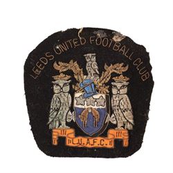 Collection of Leeds United enamel badges, including League Champions and League Winners examples, and a embroidered LUAFC patch