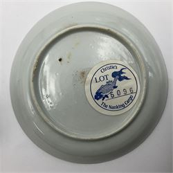 Two Chinese Nanking cargo tea bowls and saucers, circa 1745, the first example decorated with pine tree pattern within diaper borders, the second decorated with pagodas, rocks and trees, diaper borders, all with Christie's The Nanking Cargo sale label to bases, saucer D10cm