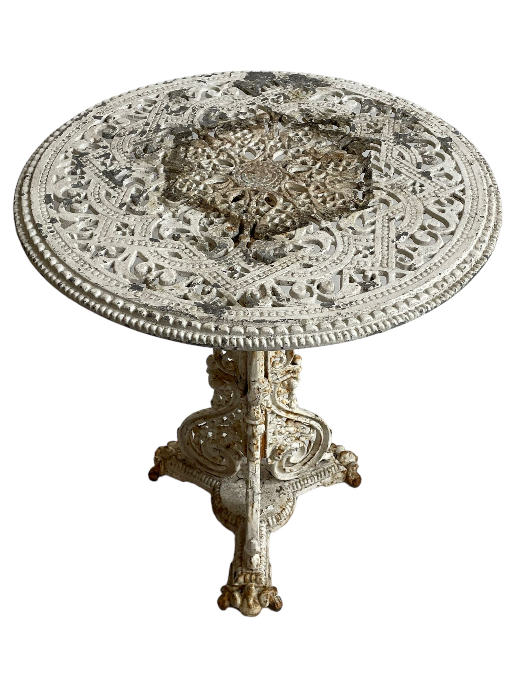 Coalbrookdale design - 19th century cast iron and cast alloy garden table, circular top with beaded edge pierced with scrolls, the pedestal decorated with scrolling and foliate motifs triple arm platform bass with scrolled feet