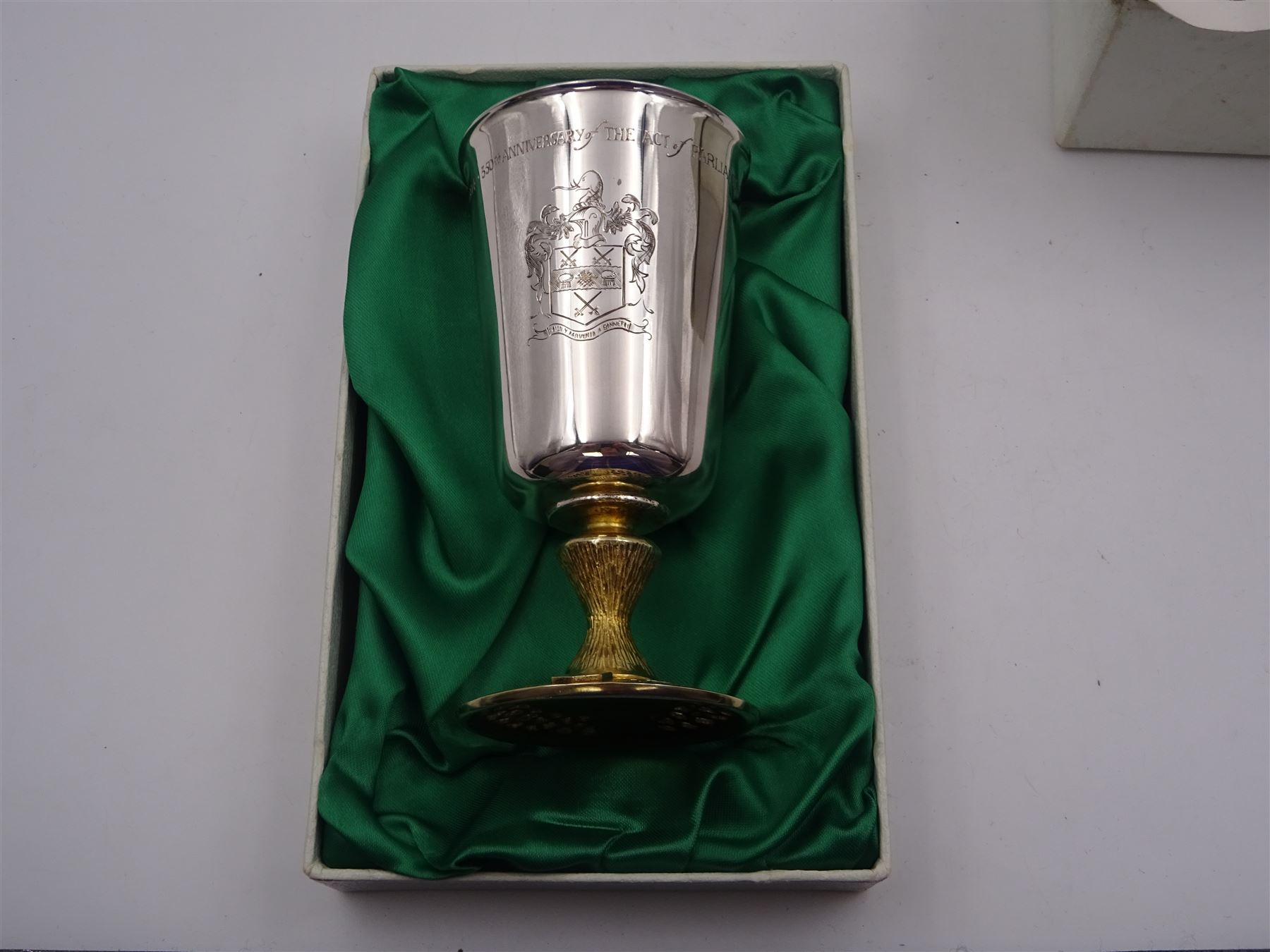 Modern limited edition silver goblet to commemorate the 350th anniversary of the Act of Parliament founding the Company of Cutlers, the tapering cylindrical bowl engraved with crest, with gilt interior and upon parcel gilt textured knopped stem and pierced circular foot, hallmarked James Dixon & Sons, Sheffield 1974, number 21/210 , in original fitted box with paperwork
