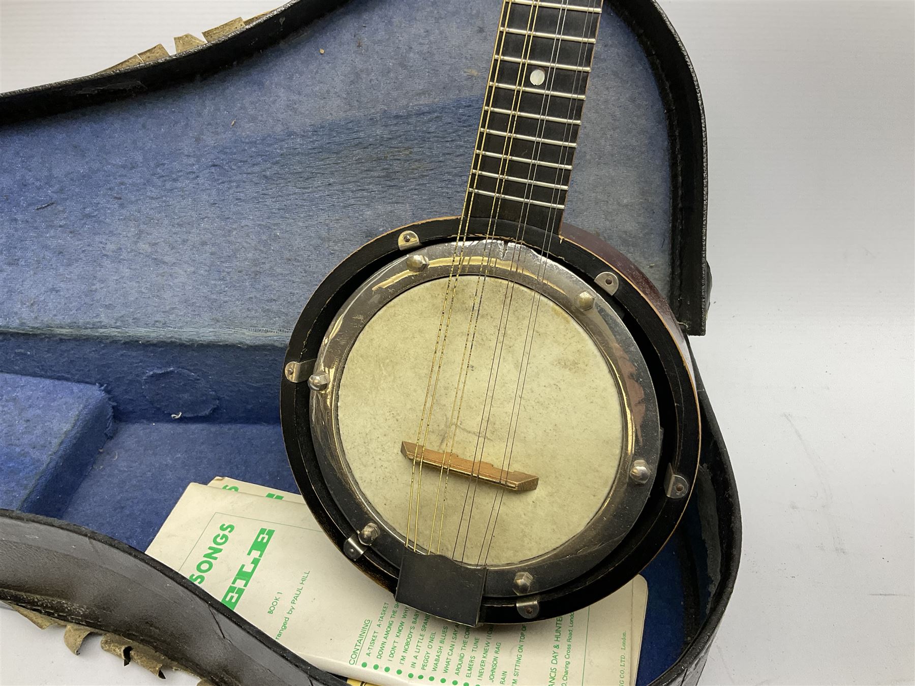 Dulcet eight-string banjo mandolin with mother-of-pearl inlaid ebonised fingerboard L55.5cm; cased; and Irish mahogany bodhran hand drum with inlaid stringing and vellum top D46.5cm; in soft carrying case with double ended beater (2)