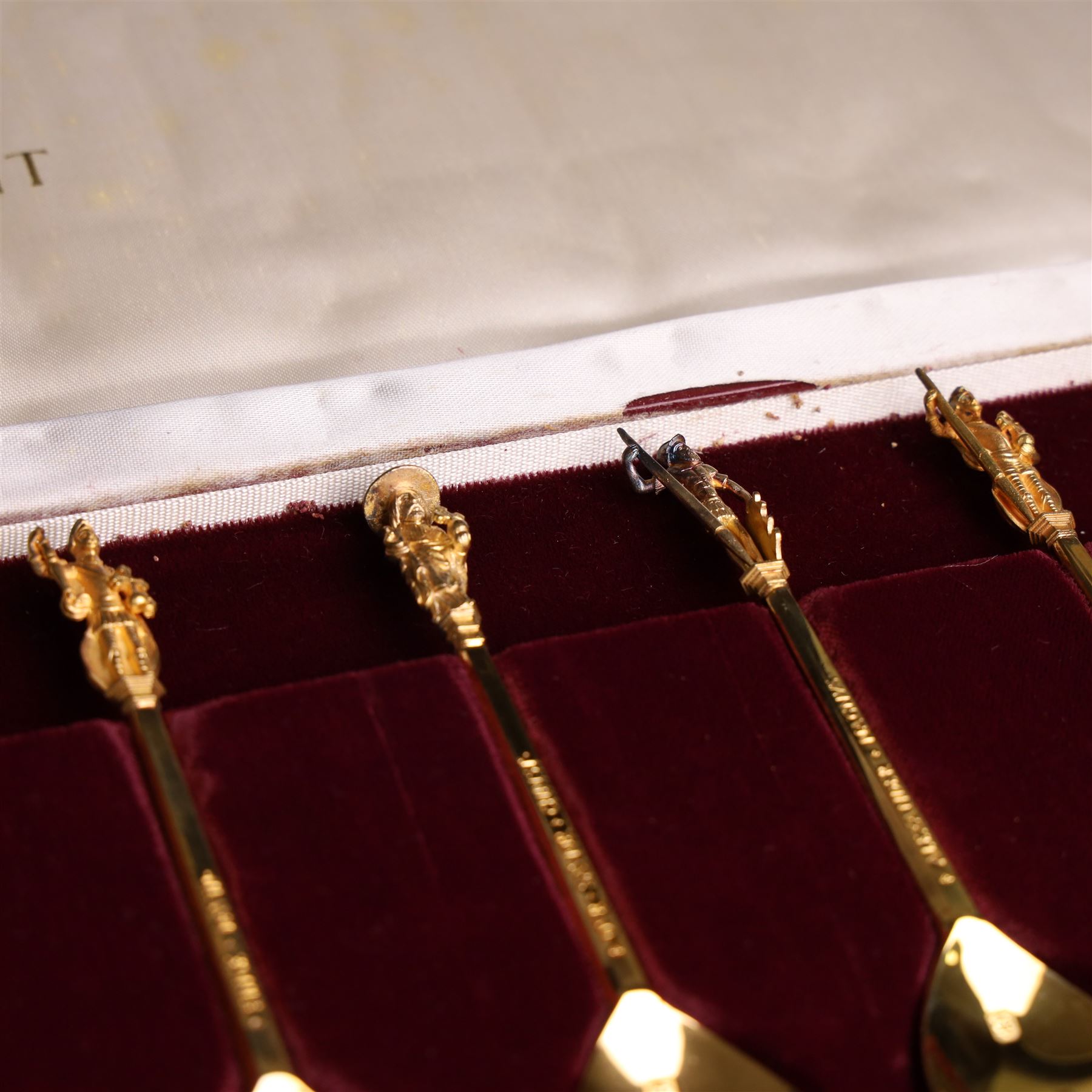 Set of twelve 'The Tichborne Collection' silver gilt spoons, each with fig shaped bowls, the finials depicting different historical figures including Queen Elizabeth, Hector of Troy and Saint Peter, hallmarked Birmingham Mint 1978, in fitted case