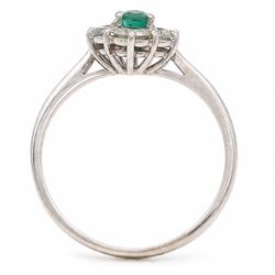 White gold emerald and diamond cluster ring, single oval cut emerald of approx 0.25 carat, surrounded by six round brilliant cut diamonds, stamped, total diamond weight approx 0.30 carat
