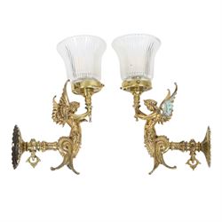 Pair of Victorian style wall sconces, each modelled as a caryatid supporting a single light fitting in one raised arm, with tapering and fluted clear glass shade, approximately H31cm D21cm