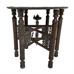 Anglo-Indian Benares table, circular pierced copper top decorated with trailing foliage, on folding hardwood stand carved with scrolls and incised decoration