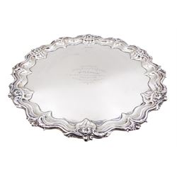 Edwardian silver salver, of circular form with personal engraving to centre, the shaped border cast with flower heads and scrolls, upon three stylised scroll feet, hallmarked Walker & Hall, Sheffield 1904, D37cm, approximate weight 36.71 ozt (1141.6 grams)
