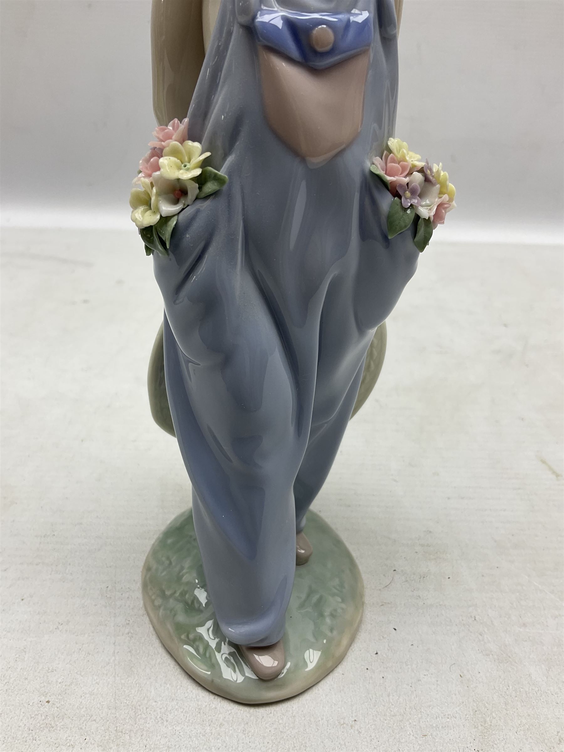 Three Lladro figures comprising, Pocket Full of Wishes no 7650, School Days no 7604 and Spring Bouquets no 7603, all with original boxes, largest example H26cm  