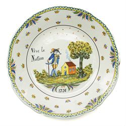 Set of four French Nevers style revolutionary faience plates, the first painted with a portrait of 'Evêque de Meaux' or the Bishop of Meaux,  another decorated with a putto holding a flaming torch and a flag inscribed 'W Lamour' beneath a slogan 'Cest le moment de faire un petit enfant' or 'Now is the time to make a child', another decorated with 'Vive les bons citoyens' or 'Long live the good citizens' within foliage, and another with a portrait of an officer, probably Napoleon, with the phrase 'Vive la Nation' or 'Long live the Nation', each bearing dates, with indistinct blue monogram to bases, D24cm (4)
