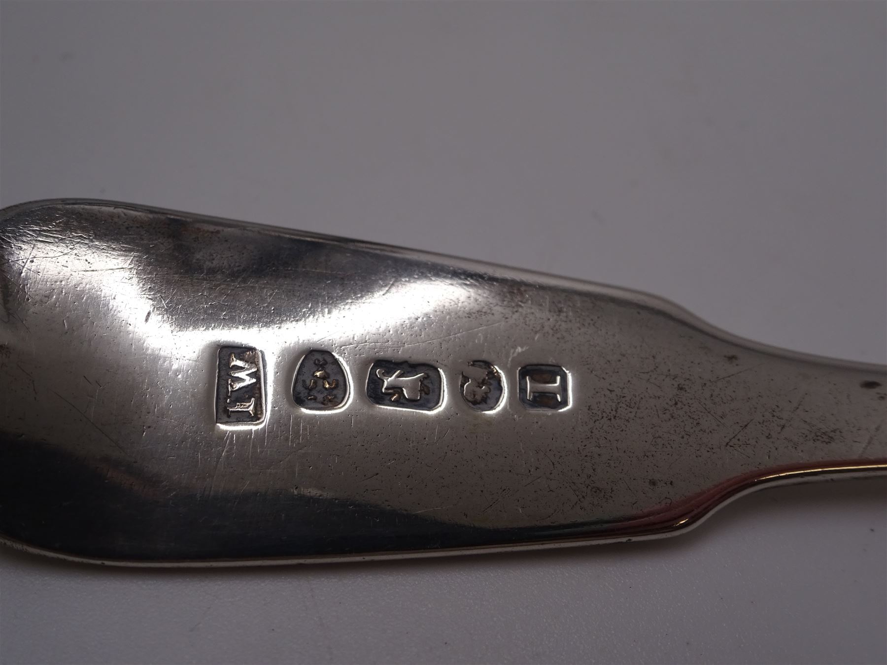 George III Exeter silver Old English pattern table spoon, engraved with foliate decoration, initials and dated 1784 to terminal, hallmarked Exeter 1783, maker's mark indistinct, together with Newcastle silver Fiddle pattern butter knife, hallmarked John Walton, Newcastle 1823, Victorian Exeter silver spoon, engraved with floral design to underside of bowl, hallmarked Josiah Williams & Co, Exeter 1875