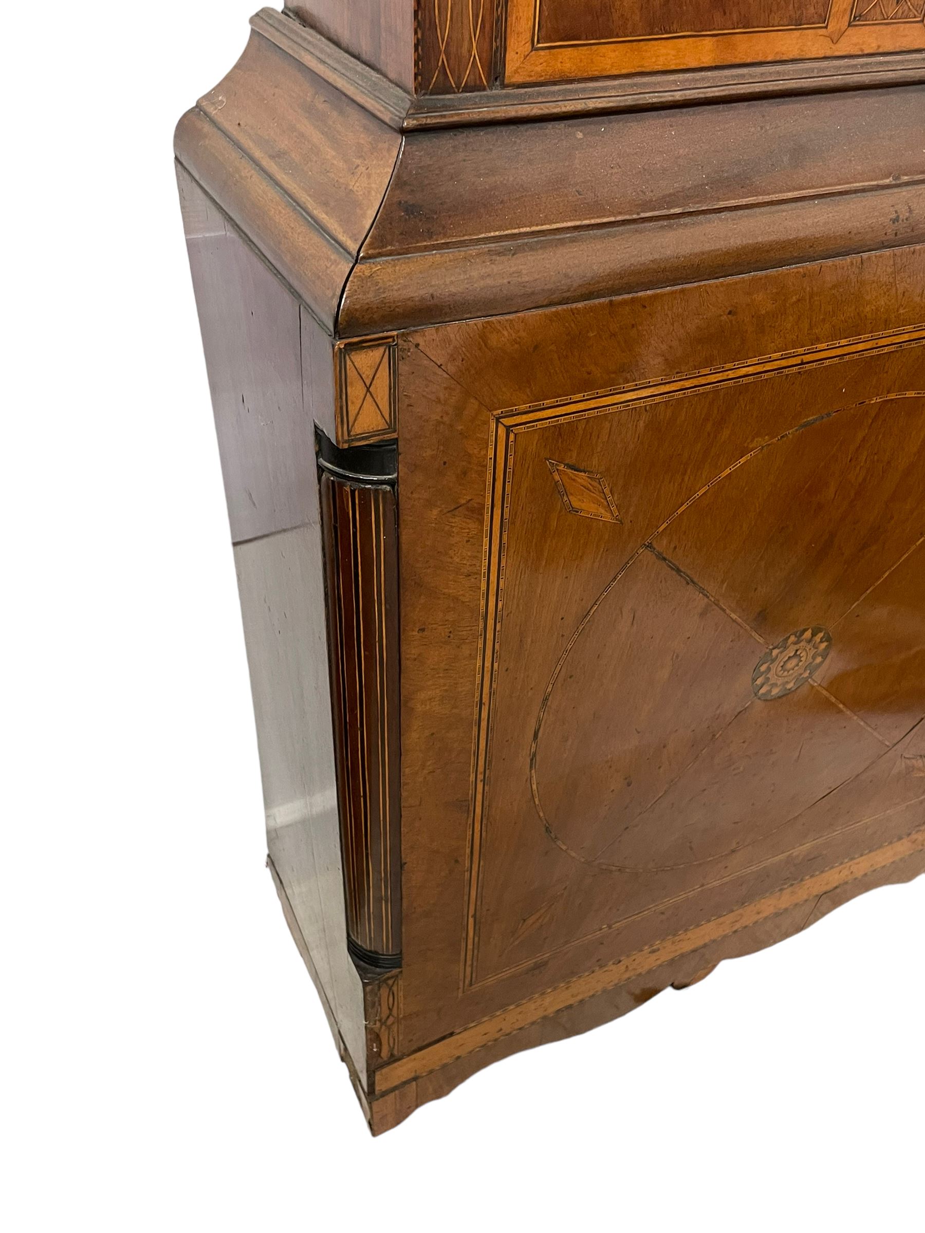 John Stonehouse of Leeds - mahogany 8-day longcase clock with a painted oval dial c1830, hood with a swans necked pediment and profuse contrasting inlay to both the hood and case, oval hood door with flanking pilasters and Corinthian capitals, conforming case with canted corners and short triple spire door, broad plinth with matching inlay and canted corners on shallow base, dial depicting masonic regalia, symbols, and pictorial depictions of the humanities, faith, hope, charity and righteousness, black chapter with white roman Arabic’s, date recorder and matching “crown” hands, dial pinned to a rack striking movement with a recoil anchor escapement, striking the hours on a coiled underslung gong. With weights and gridiron pendulum. 
This clock case is of large, impressive dimensions and was almost certainly commissioned for a large masonic lodge in Leeds, a rare and unique example.