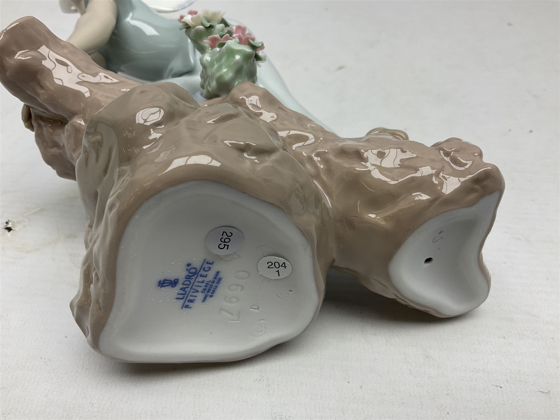 Lladro Privilege figure, Prince of Elves, modelled as an elf with wings leaning upon a rock, with original box, no 7690, sculpted by Joan Coderch, year issue 2001, year retired 2003, H23cm