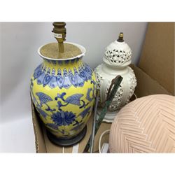 Oriental table lamp decorated with blue blossoming branches on yellow ground, together with further table lamps, brass oil lamp, carved wood mask etc, together with quantity of shades in three boxes
