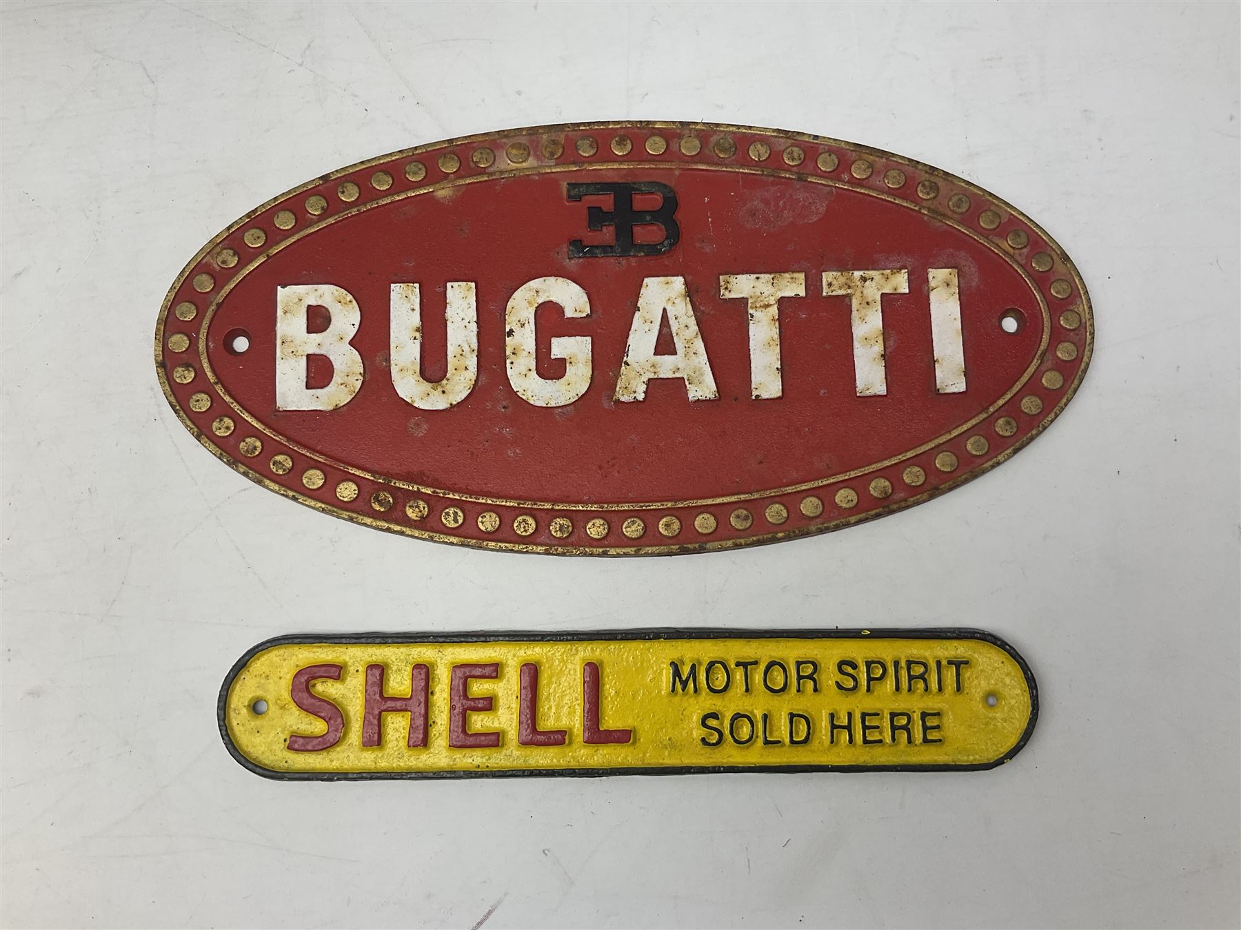 Bugatti cast iron sign with a red background, Shell Oil cast iron sign with gold background, together with Land Rover oil can, motorist warning lamp & torch tool kit and other motoring items 