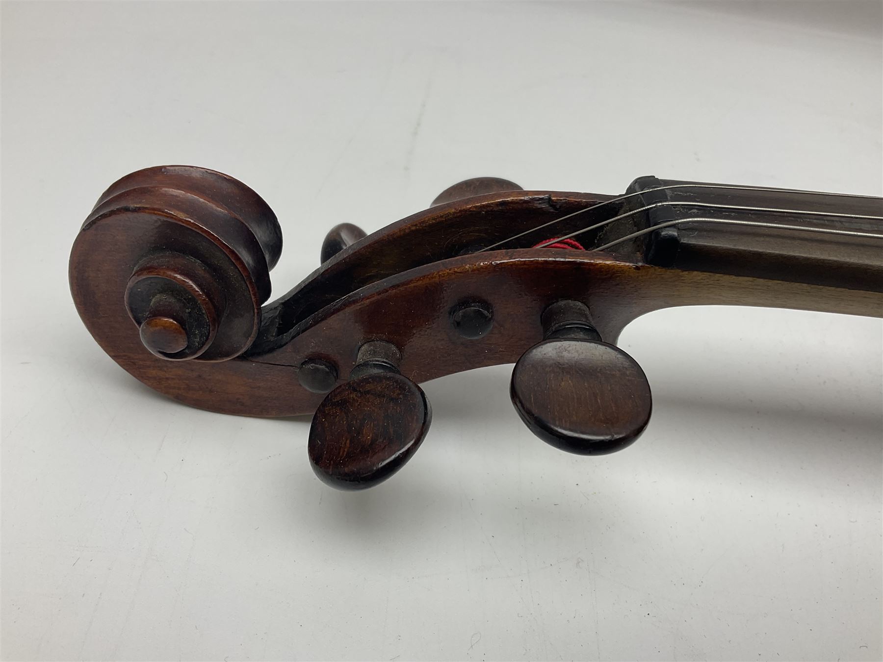 German violin c1890 with 36cm two-piece maple back and ribs and spruce top; bears label 'Antonius Stradivarius Cremona Faciebat Anno 1729' L59.5cm overall; in ebonised wooden 'coffin' case; and two German violins c1890 for completion - one bearing a Stradivarius label, the other a Ruggeri label; both in carrying cases (3)