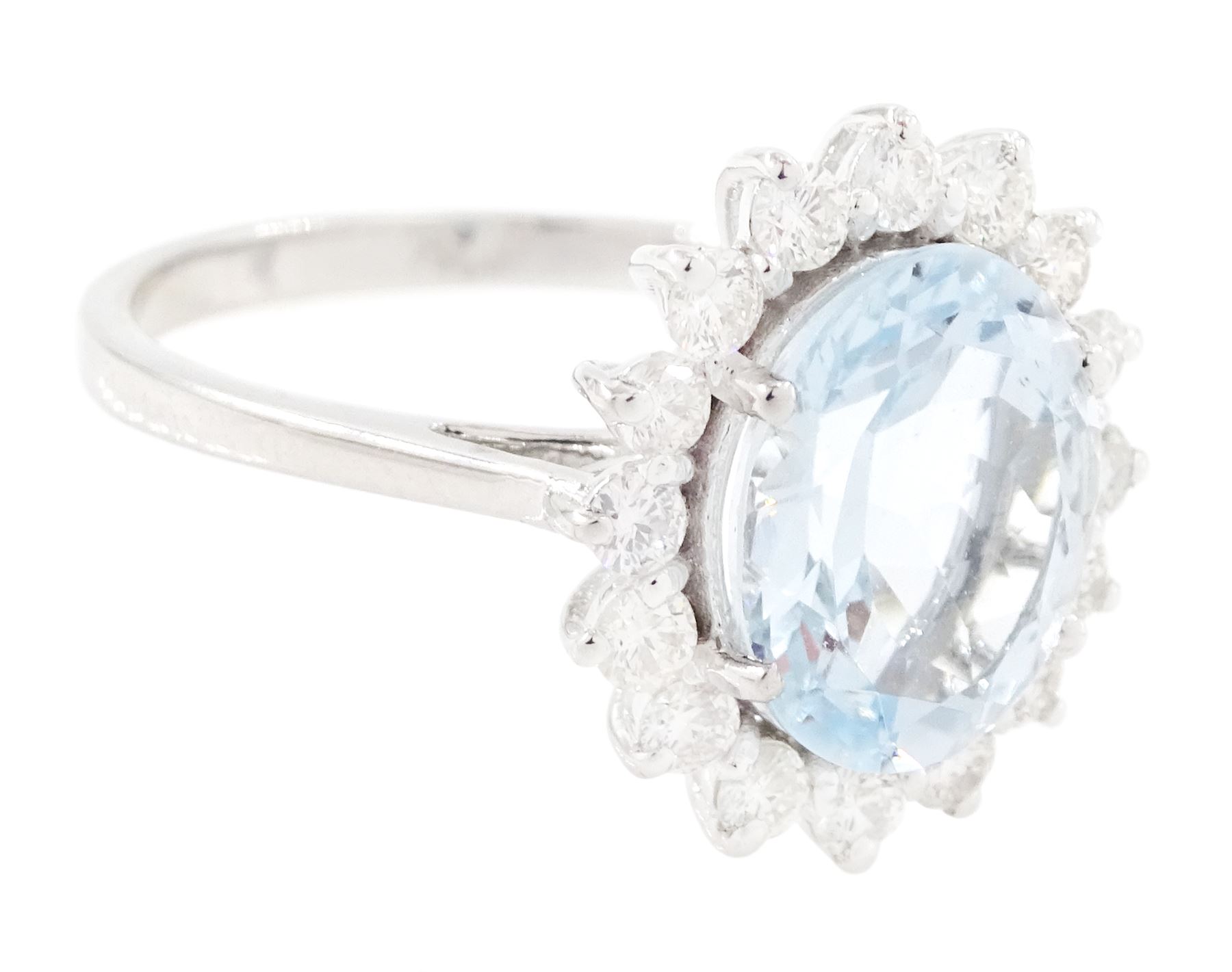 18ct white gold aquamarine and diamond cluster ring, single oval cut aquamarine of approx 2.25 carat, surrounded by sixteen round brilliant cut diamonds, stamped 18K, total diamond weight approx 0.50 carat