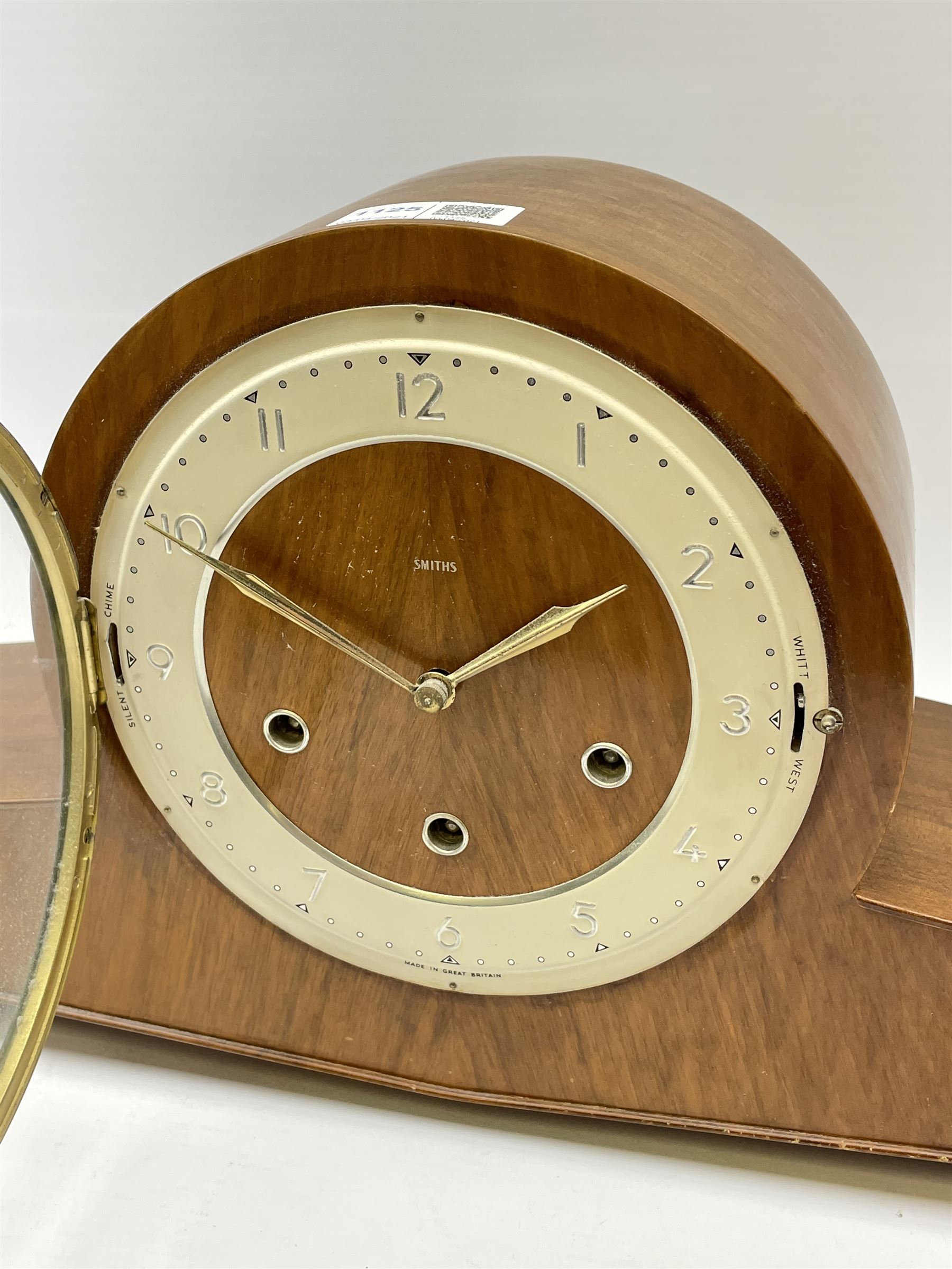 Mid 20th century walnut cased mantel clock by 'Smiths', circular dial with Arabic chapter ring, triple train driven movement with Westminster and Whittington chimes, chiming the quarters and striking the hours on rods, silent chime and West Whitt levers