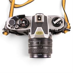 Nikon FM2 film camera body serial no. 7814849 with a Sigma 24mm lens serial no.5083190, camera user manual and Nikon carrying case