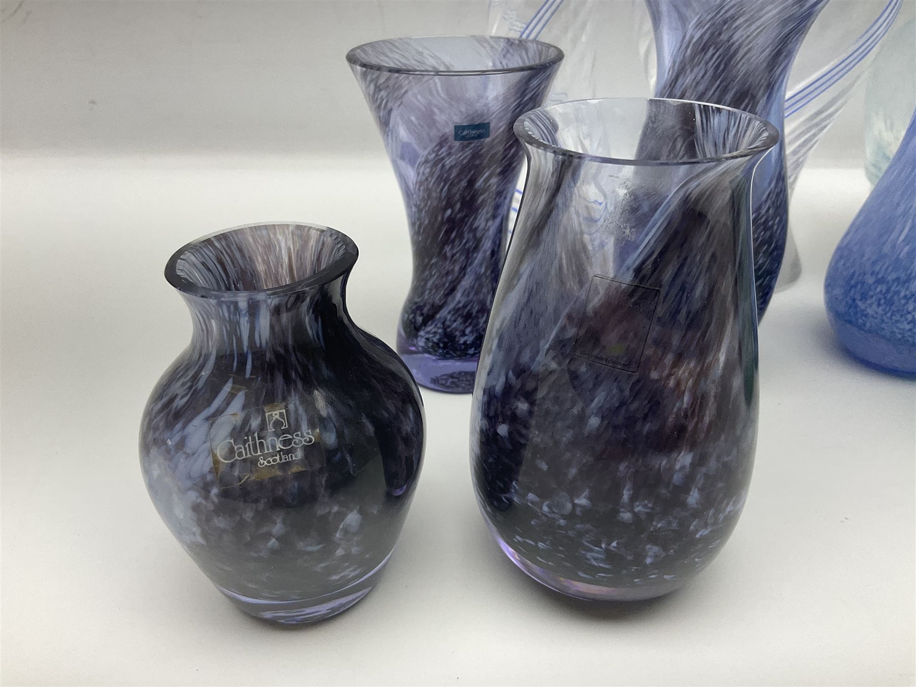 Collection of green/blue Caithness glass vases, to include mottled and swirl designs, largest 20cm (26)