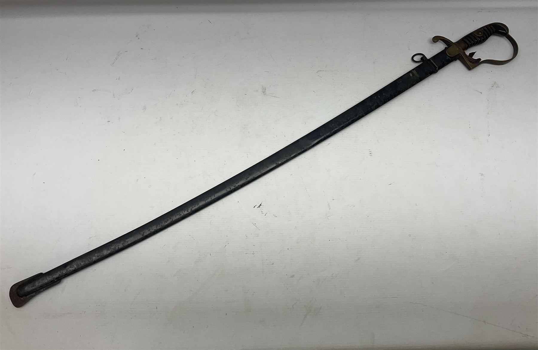 Prussian artillery officer's sword, with 80cm slightly curving fullered  blade, brass hilt with D-shaped langets, curving knucklebow, wire-bound black grip and leather finger loop; in black painted steel scabbard with single suspension loop