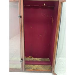 Late Victorian mahogany former gun cabinet to accommodate twelve guns, the pair of glazed doors with knob handles and glazed panels over, opening to reveal a baize lined interior; inset ivorene plaque for Taylor brothers Showcase manufacturers; L91cm H134cm D39cm