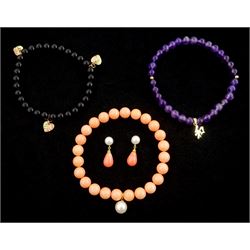  Pair of gold pearl and coral pendant stud earrings, similar bracelet, amethyst bead pendant with gold Chinese emblem pendant and one other black bead bracelet with gold leaf pendants, all 9ct