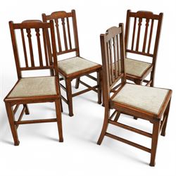 Early 20th century oak dining chairs, the shaped top rail above a triple splat back with p...