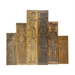 Six 20th century hardwood Dutch folk art Speculaasplank or biscuit moulds, typically carved with figures in traditional dress, largest H101cm