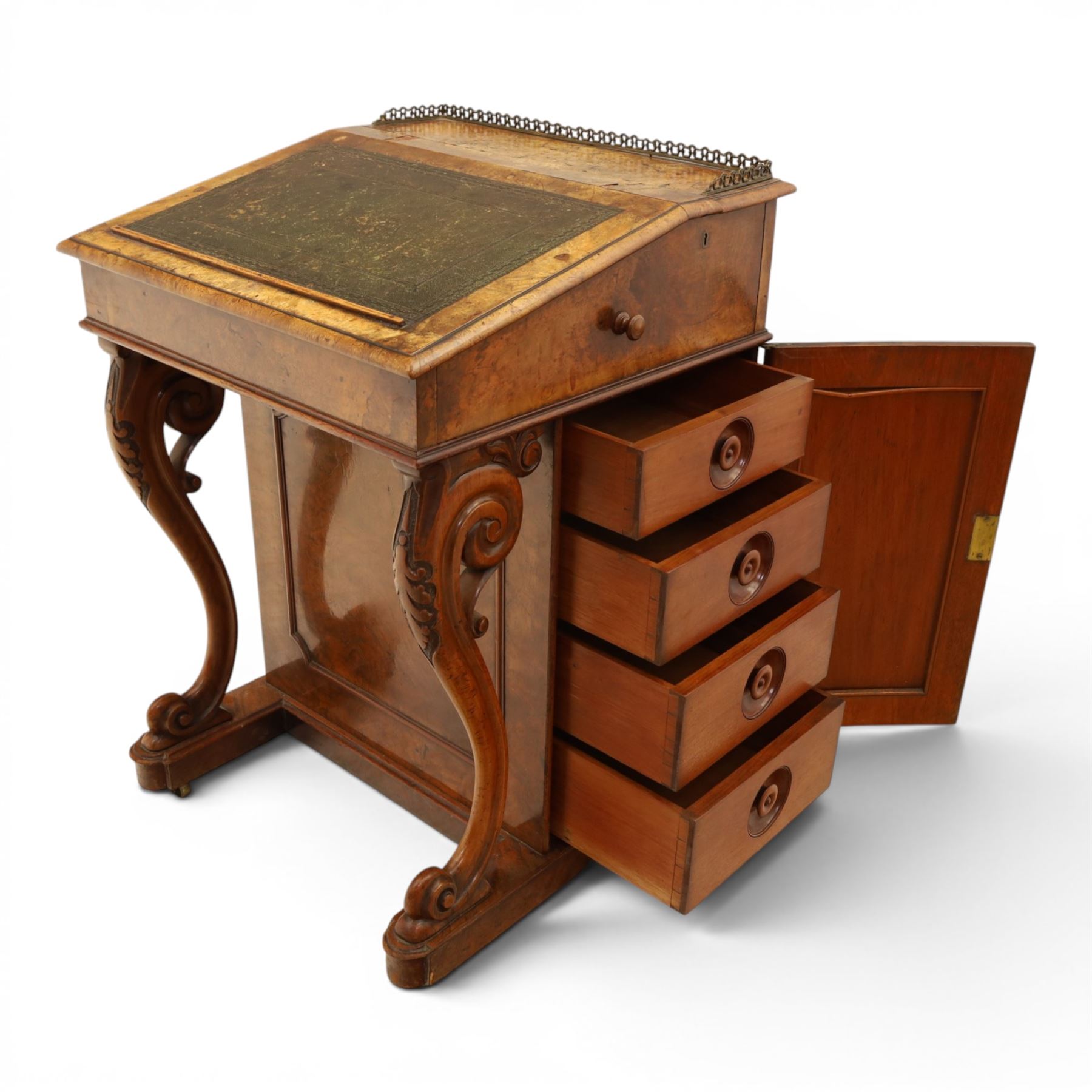 Victorian figured walnut Davenport, the fixed fall with drawer to the side enclosing writing compartment, green tooled leather writing inset, galleried back rail, right side fitted with four drawers behind a panel, opposing panelled side, raised on carved cabriole front supports with scroll terminals and platform base