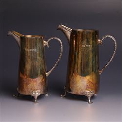 Two graduating silver milk jugs, each of tapering cylindrical form, with engraved central cartouche to body and upon three paw feet, hallmarked Christopher Nigel Lawrence, London 1988, tallest H13cm