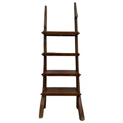 Chinese hardwood free standing bookcase or shelving unit, two naturalist branch uprights supporting four shelves, with Chinese export stamp