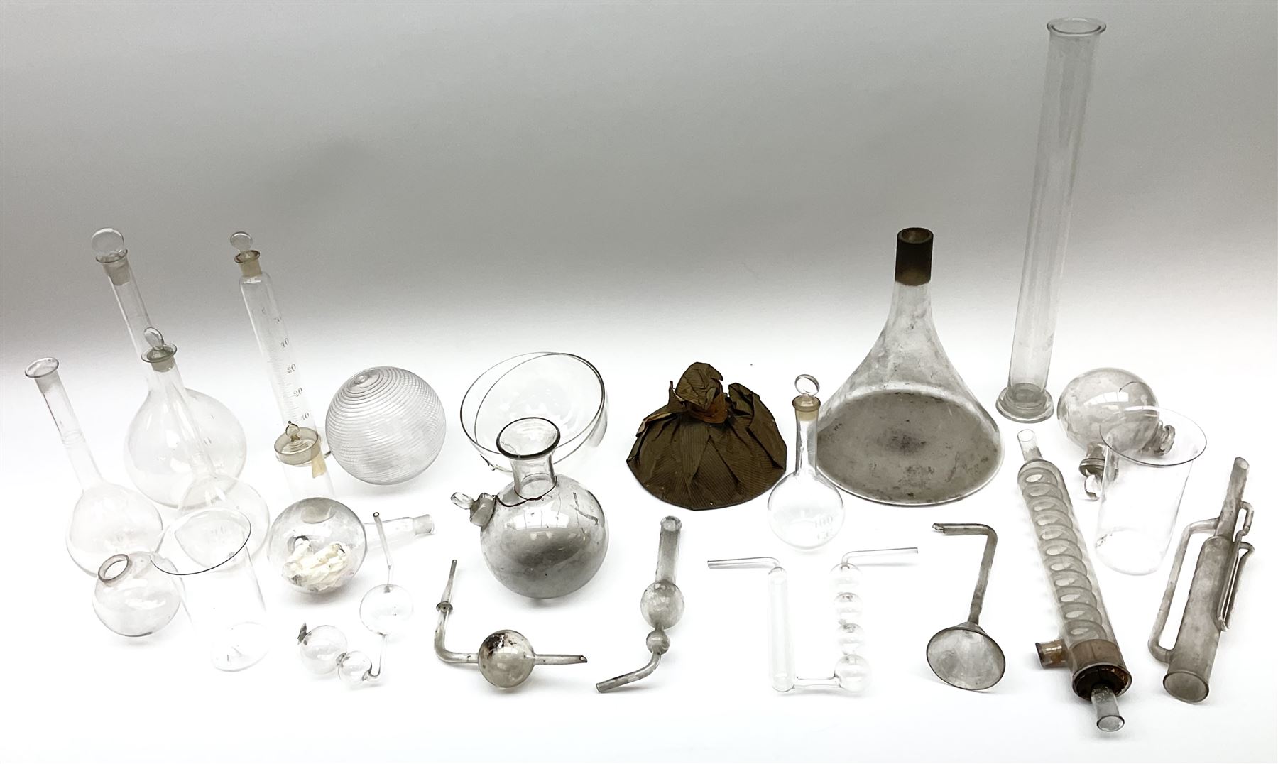 Collection of 19th century and later pharmaceutical laboratory glass, to include, volumetric flasks of various sizes, conical flask, stratus flask, etc (25) Provenance: discovered in the storeroom of a long established Hull pharmacist and opticians