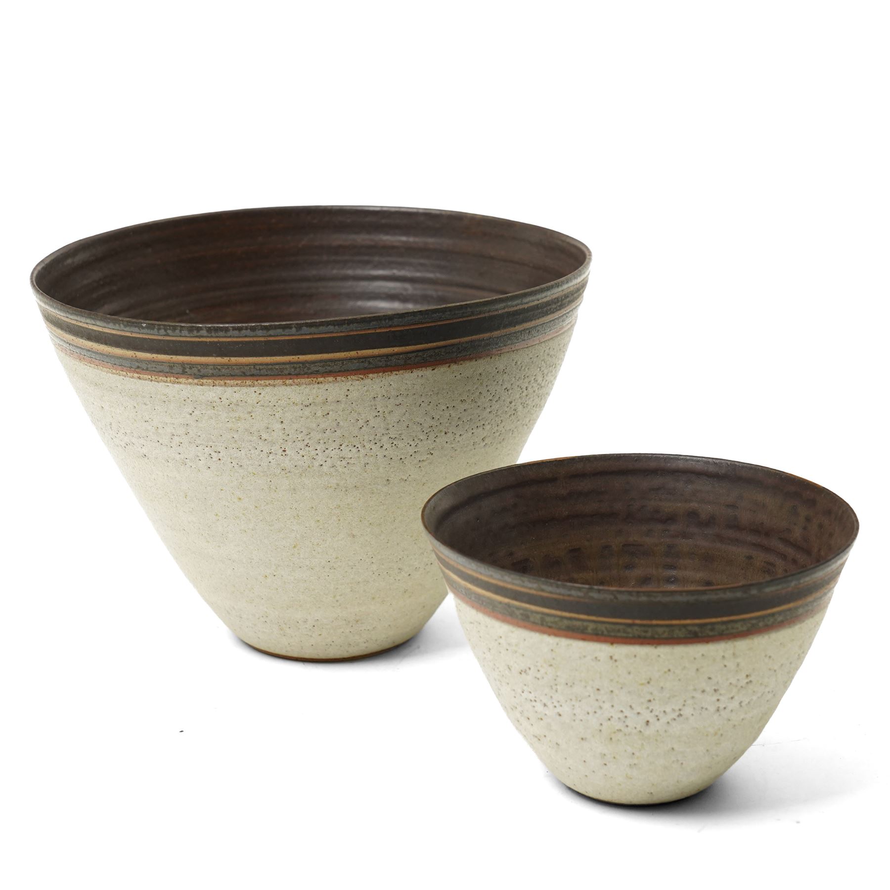 Sarah Butler and Martin Clark: Three works, comprising two bowls and a sleeve vase, each with incised potters mark to bases, and one with Heals mark, sleeve vase H24cm (3)
