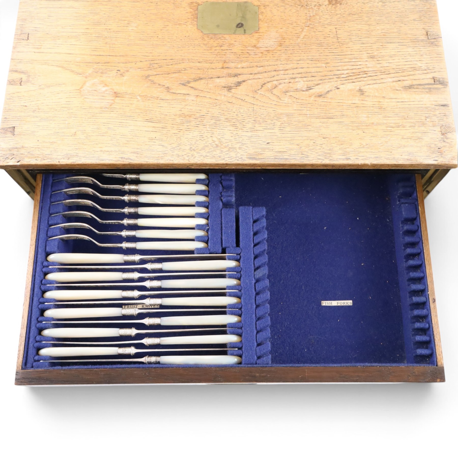 Ealy 20th century oak canteen, with five drawers behind double doors, four drawers containing a part set of silver plated Hanoverian pattern cutlery with engraved monograms and a set of twelve mother of pearl handled fruit knives and forks, the last drawer containing a collection of loose silver plated cutlery, canteen H39cm, W48cm