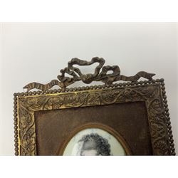 19th century portrait miniature on enamel, depicting a Georgian lady in period dress, hand painted with gilt detailing, in gilt frame with fruiting vine details, overall H13.7cm