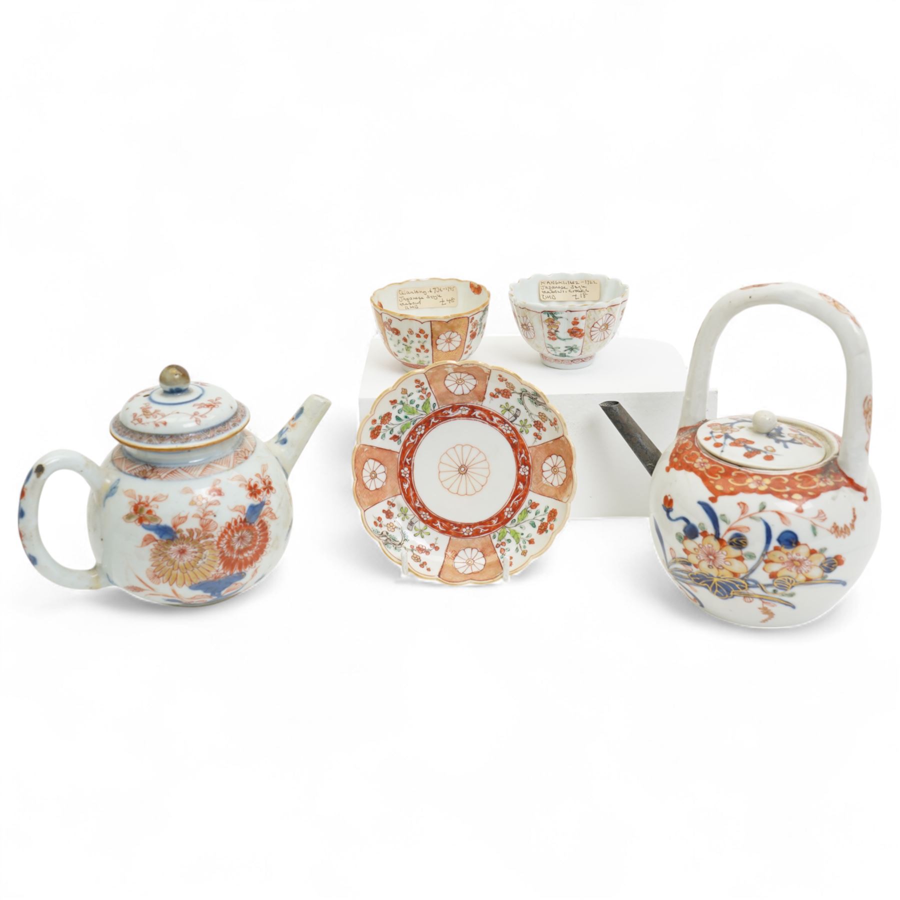 Two 18th century Chinese Imari teapots, together with two Imari pattern tea bowls, approximately Kangxi and Qianlong period, and one saucer, one tea bowl with double ring mark to base, largest teapot H16cm (5)