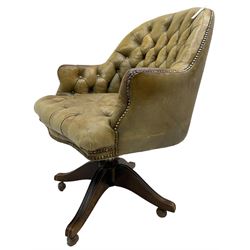 Early 20th century swivel desk chair, upholstered in buttoned sage green leather with studwork, on adjustable action with castors