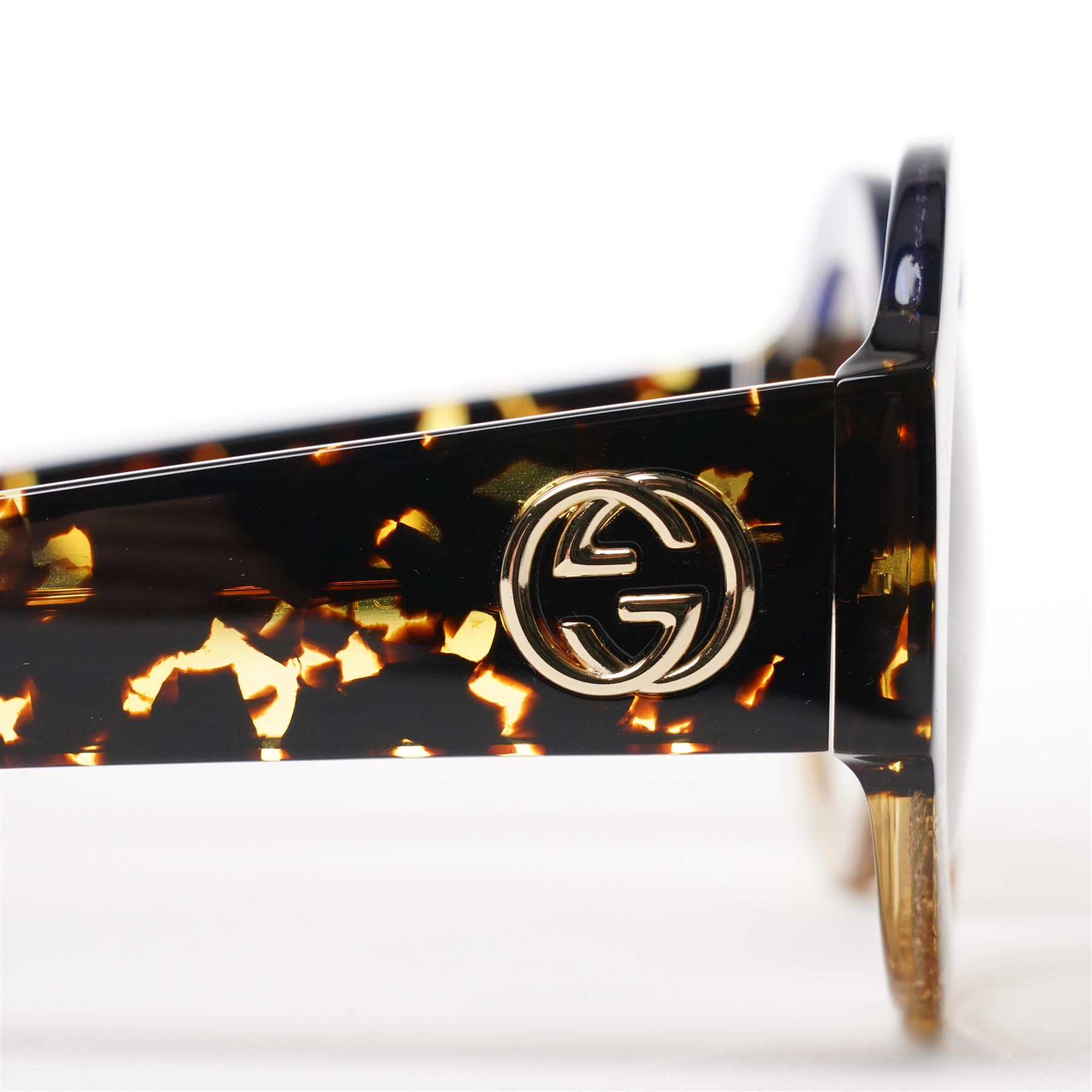 Gucci - pair of oversized round sunglasses, with gradient tinted lenses in a tortoiseshell-effect frame with blue and gold glitter inlay, the temples with interlocking gold-tone GG logo and bee motif, unused with original cloth and hard cases