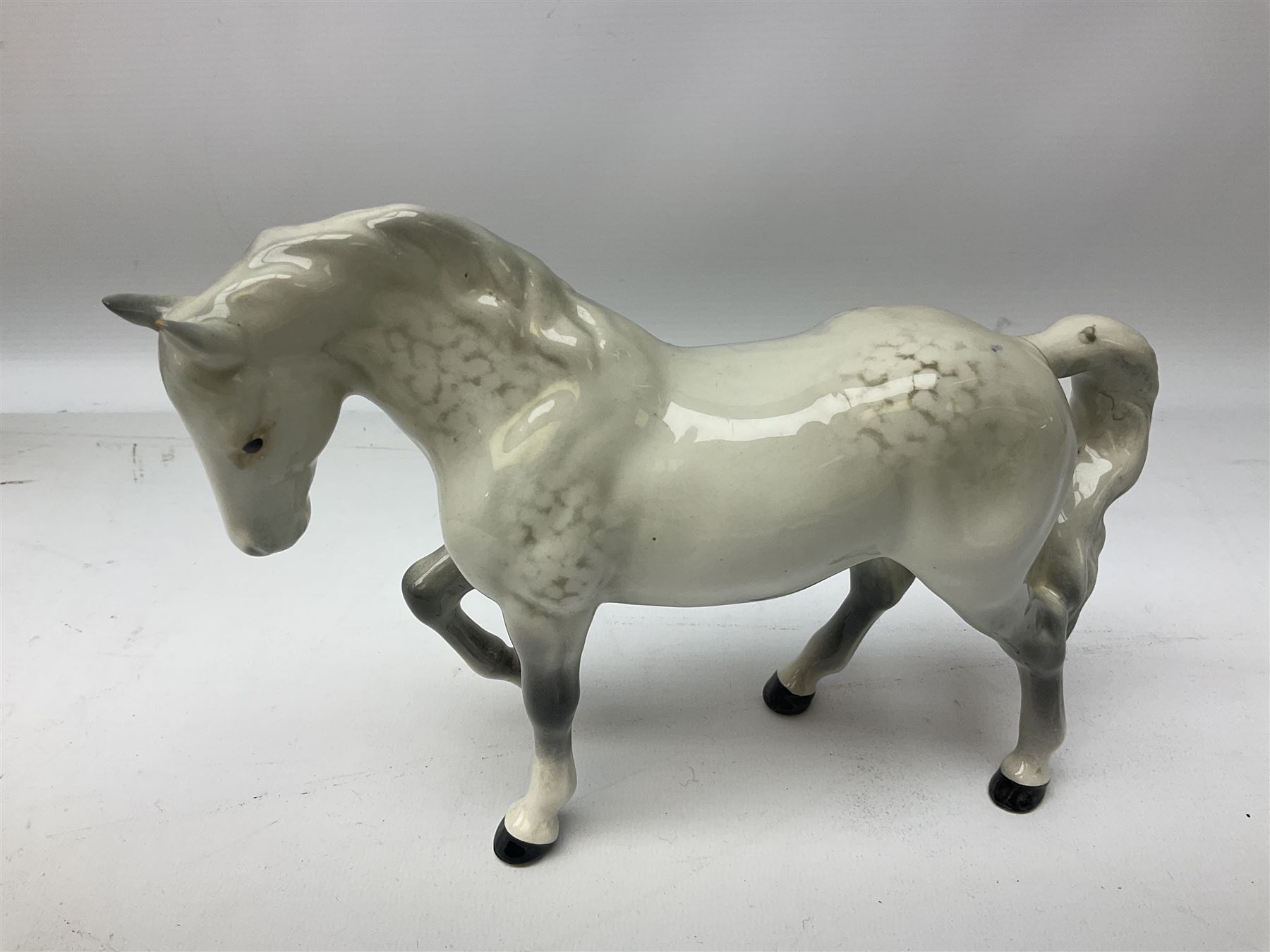 Collection of Beswick horses, including grey horse no.701, palomino foal no 836, grey stocky jogging mare no.855 etc, together two Royal Doulton horses, (8)