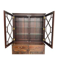 Acorn Industries - Georgian design mahogany bookcase on cupboard, fitted with two astragal glazed doors enclosing three glass shelves, base with two cock-beaded drawers over two panelled cupboards, inlaid with acorn signature, by Alan Grainger, Brandsby