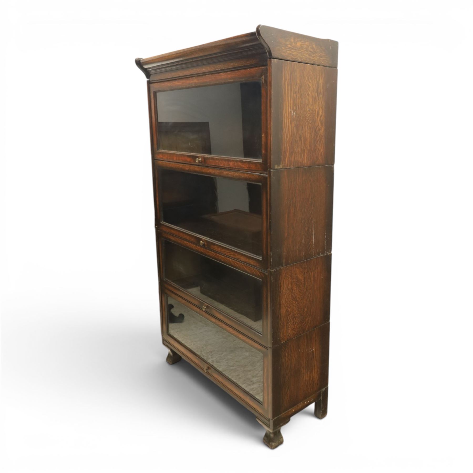Harris Lebus - oak barrister stacking bookcase, four tier design with glazed fronts with brass knobs, raised on claw and ball feet