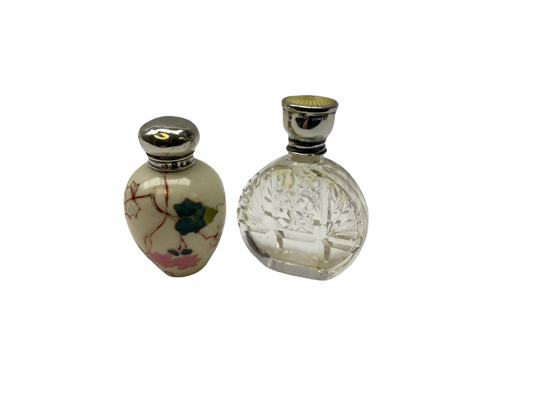 Cut glass perfume bottle of bellied form, the silver mounted cover with turquoise guilloche enamel top, hallmarked Henry Perkins & Sons, London 1927, together with a cut glass perfume bottle with silver mounted and yellow guilloche enamel lid, hallmarked Albert Carter, Birmingham 1950, Continental silver perfume bottle, of barrel form with embossed figural detail, stamped 930, scent bottle of bellied form with white metal foliate pierced overlay, amethyst glass scent bottle of flask form with foliate embossed white metal cover and suspension ring and chain, and three further examples, including one of ovoid form with painted decoration and silver cover, hallmarked for Birmingham.