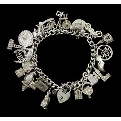 Silver curb link bracelet with heart locket clasp and twenty five silver charms including toby jug, poodle, parrot and pig charms