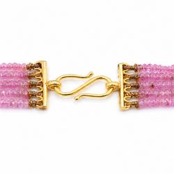 18ct gold pink sapphire necklace, five graduating stands of faceted pink sapphires, with an 18ct gold clasp, London 2004