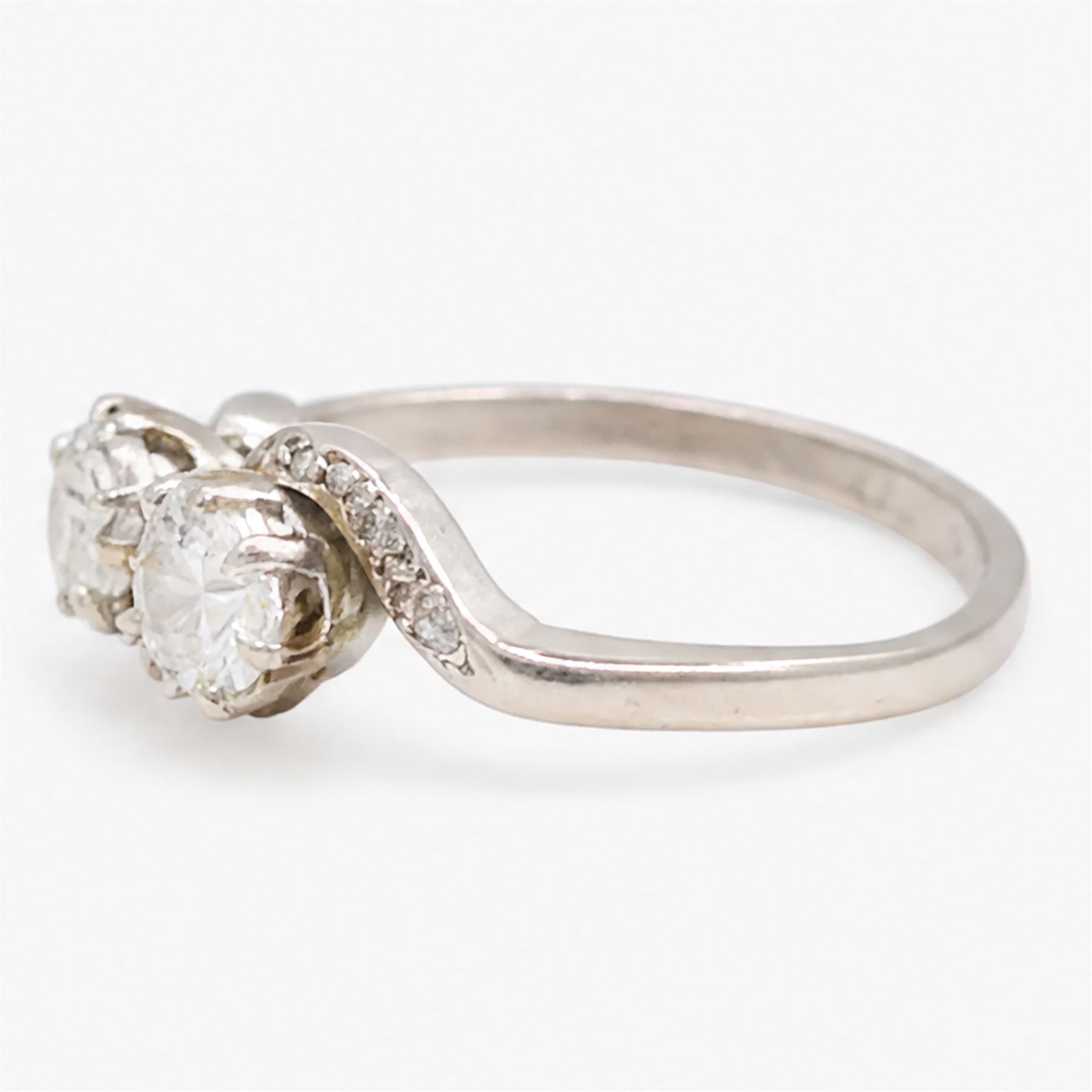 Platinum diamond crossover ring, set with two round brilliant cut diamonds and diamond set shoulders, stamped, total diamond weight approx 0.65 carat
