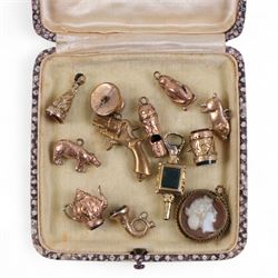 Collection of gold plated charms, including teapot, monkey, cameo etc