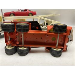American Nylint large scale tin-plate car transporter L59cm carrying a Testor Toys plastic car; Tonka tin-plate mobile crane; boxed Sarony Cigarettes tin-plate roulette game with rules; and Japanese style tin-plate box, the lid inset with a revolving poker dice game (4)
