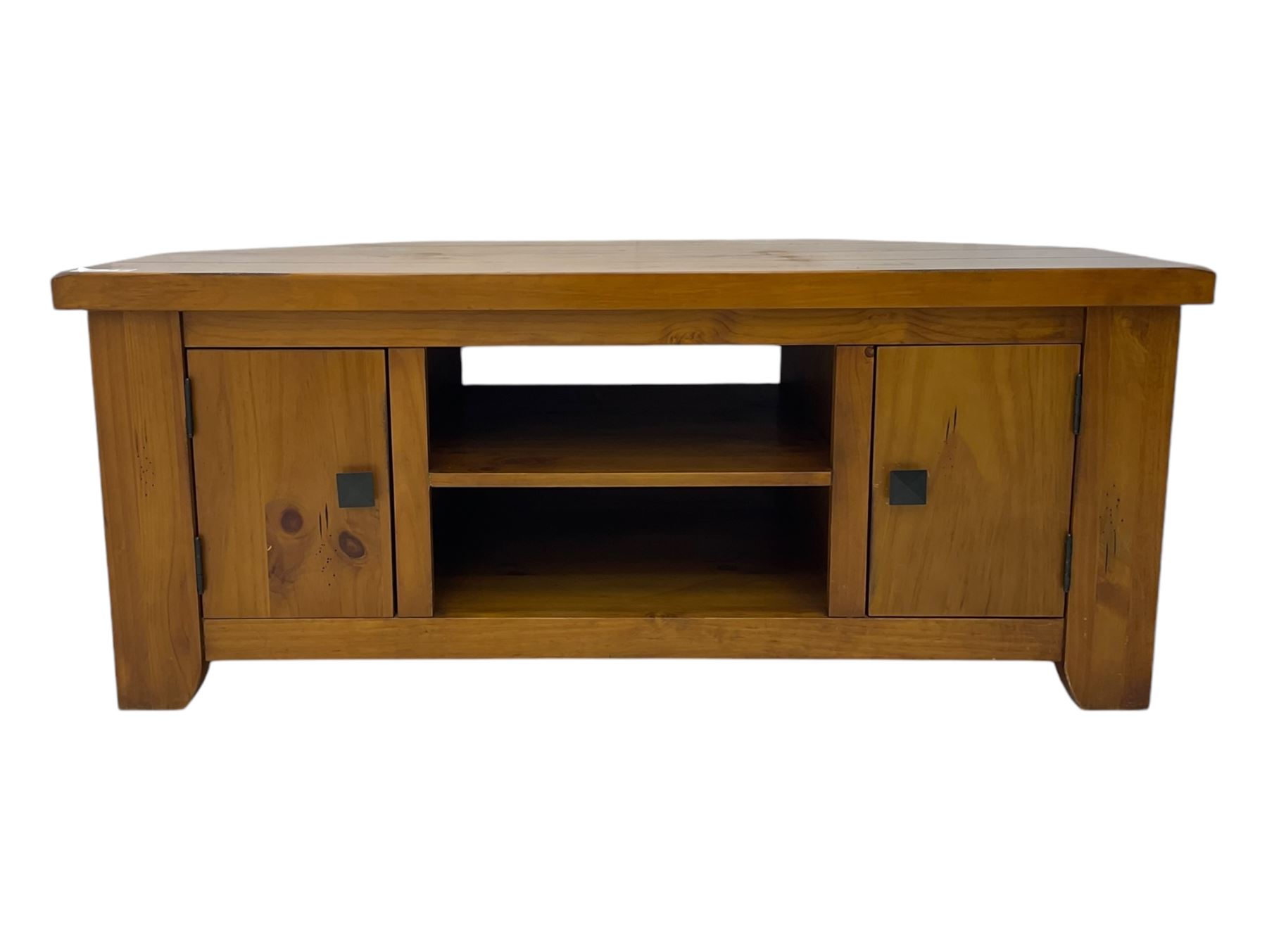 Contemporary mango wood television stand, wide planked surface and angled back corners, central shelving section flanked by twin cupboard doors with square pull handles, raised on stile supports